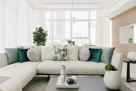 Banyan Tree Residences show apartment living room in white, oak and teal