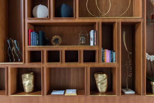 Bespoke walnut shelving with brass objects, Villa Barr Al Jissah