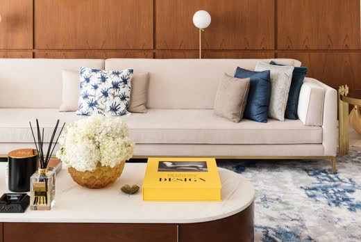 A cream sofa, navy cushions and a brass-edged coffee table, Villa Barr Al Jissah